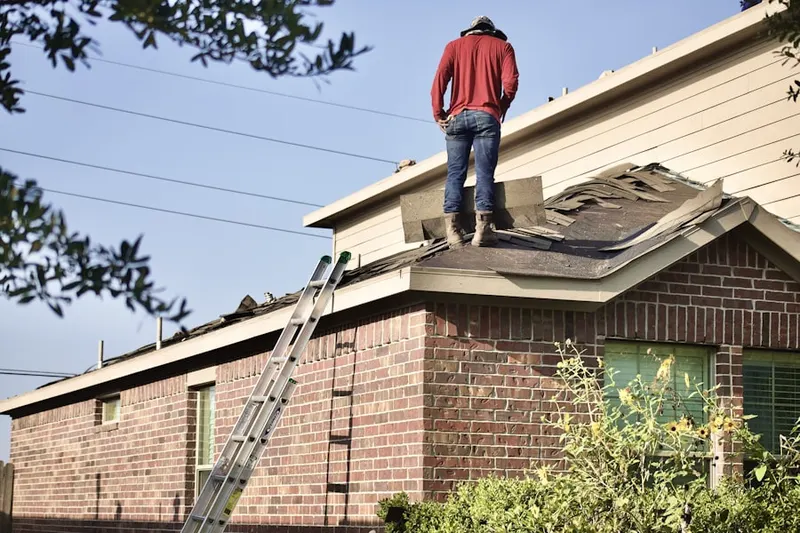 Professional roofer working on a residential roof in Village of Valleybrook